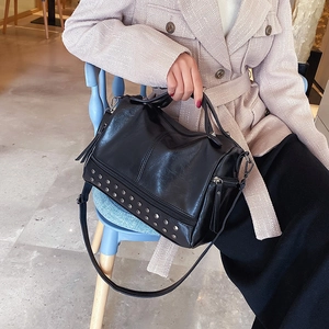 Fashionable black faux leather Boston bag with silver studs and tassel details