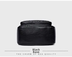 Detailed bottom view showing high-quality black faux leather texture of the travel bag