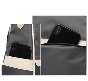 Detail of waterproof oxford fabric side pocket and silver zipper on large capacity backpack