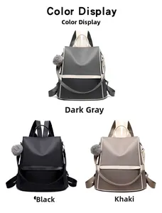 Oxford fabric backpack in black, dark gray and khaki colors with fuzzy ball charms