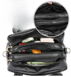 Internal detail of large capacity shoulder bag with multi-layer zipper compartments