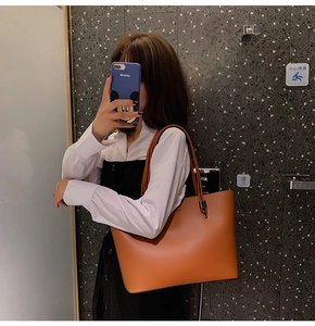 Brown vintage large tote bag with long straps shown in a lifestyle side-view shot