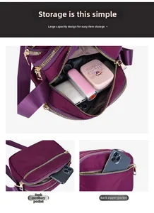 Detailed interior of purple nylon bag with multiple compartments and gold zipper puller