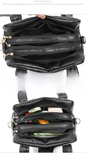 Internal view of black multi-layer bag showing three zipper compartments for organization