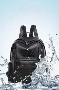 Close-up of waterproof black faux leather backpack with metallic zippers and splashing water effect