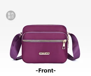 Front view of purple nylon crossbody bag with multi-layer zippers and adjustable strap