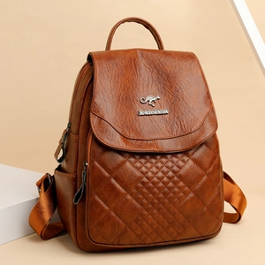 Brown faux leather backpack with diamond quilted patterns and flap closure on beige base
