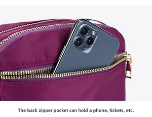 Rear zipper pocket of purple nylon crossbody bag showing large phone storage capacity