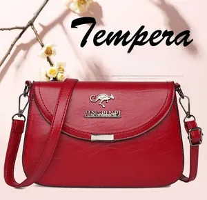 Detail of red faux leather shoulder bag with silver kangaroo logo and adjustable strap