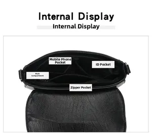 Internal view of black leather crossbody bag showing main pocket and zipper compartments