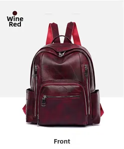Close-up of wine red lychee textured leather backpack with multiple zipper pockets