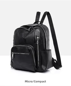 Detail view of black PU leather backpack with silver zippers and multi-pocket design