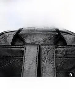 Close-up of durable reinforced stitching on the leather handle of this black backpack