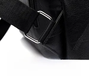 Detail of reinforced triangular stitching and metal ring on black leather backpack strap