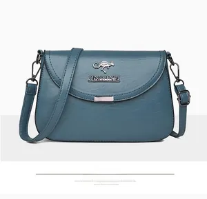 Detailed close-up of blue textured soft leather shoulder bag with kangaroo metal logo