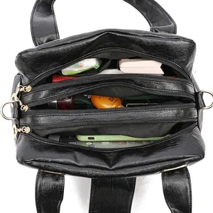 Black soft leather shoulder bag with three main zipper compartments and large capacity