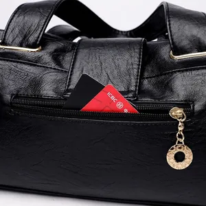 Black pebbled leather tote bag with functional back zipper pocket and gold ring detail