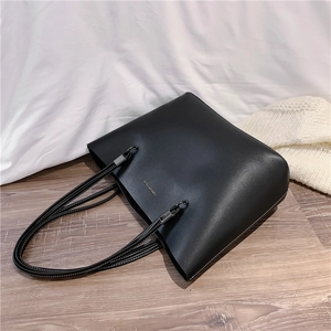 Minimalist black faux leather tote bag with gold Forever Young print for daily commute