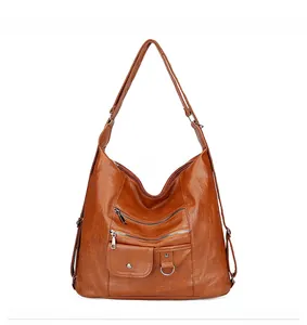 Vue détaillée du sac bandoulière marron caramel en similicuir avec plusieurs zips
