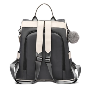 Minimalist grey Oxford backpack with anti-theft back pocket and plush ball charm