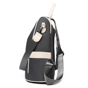 Minimalist grey Oxford backpack with beige leather trim and convertible shoulder straps
