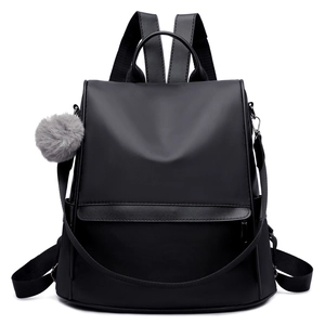 Minimalist black Oxford cloth large capacity backpack with silver zippers and pompom detail