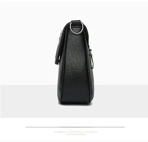 Side view of black pebble leather crossbody bag with silver hardware and D-ring detail