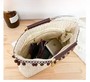 Interior view of straw handbag showing large capacity for sunglasses and essentials