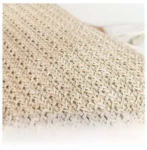 Macro view of detailed straw weaving craftsmanship on a large beach tote bag