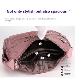 Pink nylon crossbody bag detail showing multi-compartment interior and inner zipper pocket
