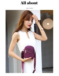 Detail of purple nylon crossbody bag with gold zippers and adjustable shoulder strap