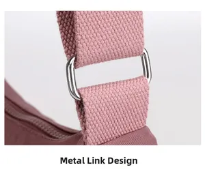 Close-up of durable silver D-ring hardware on a purple nylon crossbody shoulder bag