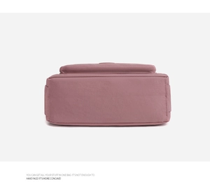 Detail view of the durable nylon crossbody bag showing the reinforced flat bottom seams
