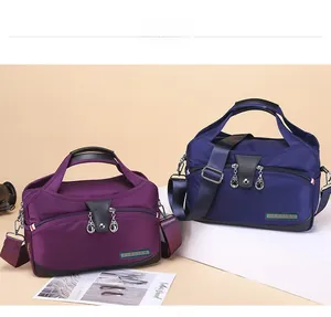 Close-up of durable purple and dark blue nylon travel bags with multi-layered zippers