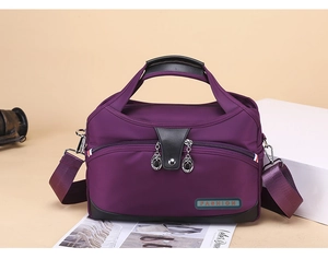 Detail of purple oxford bag showing waterproof fabric, dual zippers, and fashion label