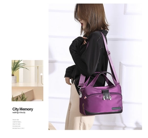 Detail view of purple waterproof oxford nylon bag showing front pocket and crossbody strap