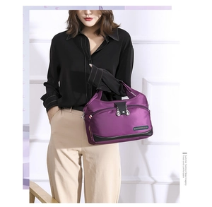 Detail view of purple waterproof oxford tote bag with fashion plate and leather accents