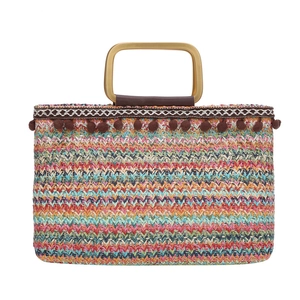 Colorful bohemian straw handbag with pom-poms and metal handles for beach and summer style