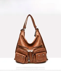 Detailed front view of brown PU leather shoulder bag with multiple zippered pockets