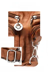 Close-up of brown litchi pattern leather with floral carved silver metal zipper pulls