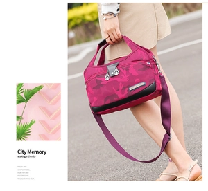Close-up of lightweight rose red camo nylon handbag with durable handles and metal logo