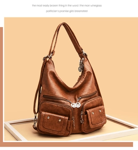 Detail of vintage brown pebble leather shoulder bag showing multiple zippers and studs