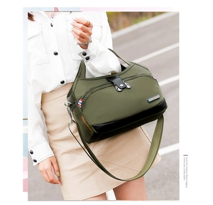 Detail view of large olive green waterproof oxford tote with multiple zipper pockets