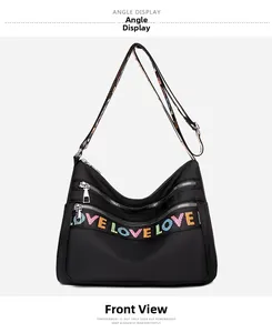 Front detail of black Oxford crossbody bag featuring colorful LOVE embroidered wide strap