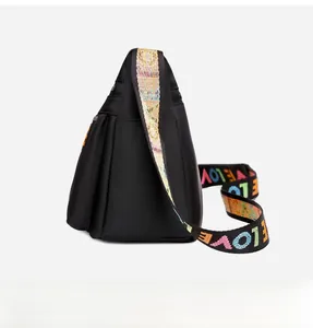Detail of black nylon crossbody bag featuring colorful LOVE patterned wide shoulder strap