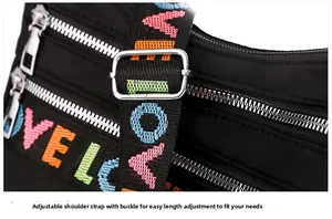 Detail of adjustable wide shoulder strap and colorful LOVE embroidery on nylon crossbody bag