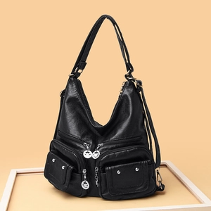 Women's black soft leather shoulder bag with multi-zipper pockets and rivet details