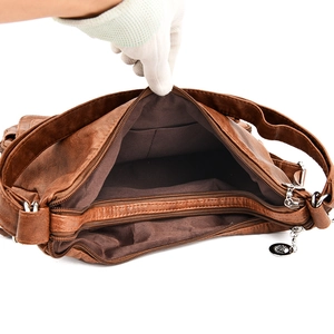 Deep brown soft leather shoulder bag featuring spacious interior compartments and zip closure