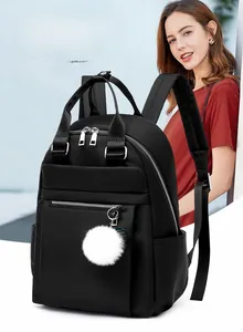 Détails du sac à dos oxford noir avec pendentif peluche blanc et fermetures éclair argentées