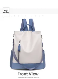 Front view of a minimalist blue and white faux leather backpack with vertical zippers